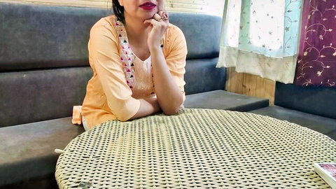 Indian step-sister in orange top sitting seductively, hinting at taboo family encounter