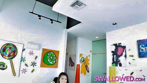 Nicole Sage deepthroating in vibrant Swallowed studio scene
