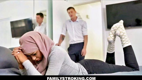 Milu Blaze in hijab lies seductively on bed with stepbrother watching