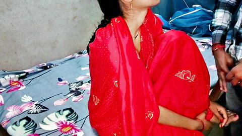 Desi woman in red saree sits with man touching her in intimate setup