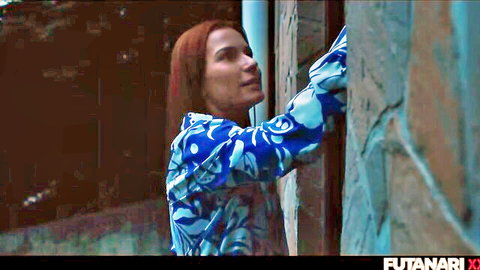 Josephine Jackson in blue patterned blouse, leaning seductively, futa tease
