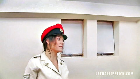 Brunette in sexy military uniform, red beret, bold lipstick