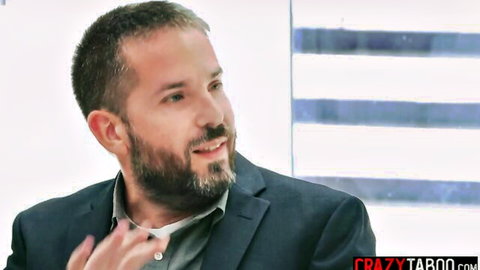 Bearded man in dark suit gesturing and smiling during professional interview on CrazyTaboo
