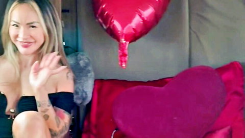 Kali Roses smiling and waving in low-cut top, teasing cleavage