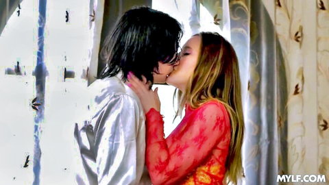 Busty blonde MILF in red lace passionately kissing dark-haired man