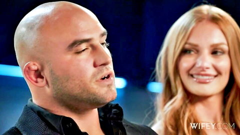 Bald husband stares intently at smiling redhead wife closeup on Wifey.com