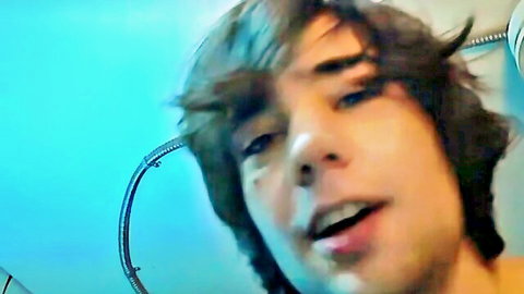 Young brunette emo twink with eyeliner sticks tongue out open mouth in amateur selfie