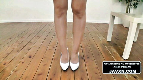 Beautiful Japanese woman in tight outfit posing with legs in white high heels
