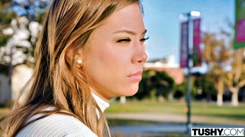 Avery Cristy in white turtleneck, thoughtful outdoor gaze
