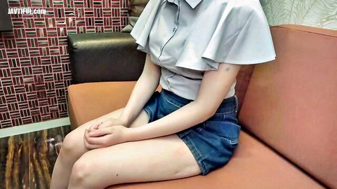 Cute big-titted Asian woman in ruffled blouse and short denim shorts