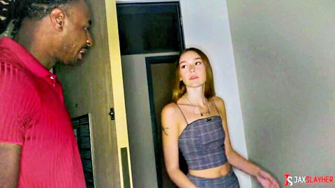 Della Cate in gray top and skirt teasing Jax at doorway