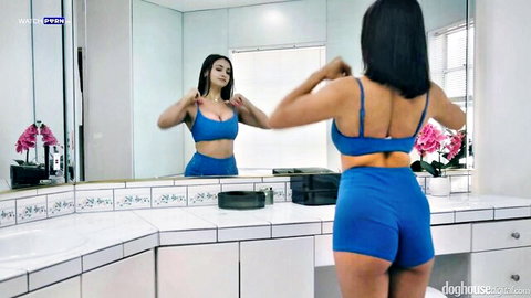 Hailey Rose flexing in tight blue bra and shorts, showing off curvy body and big tits