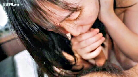 Topless Asian woman passionately kissing man's neck in close-up intimate moment