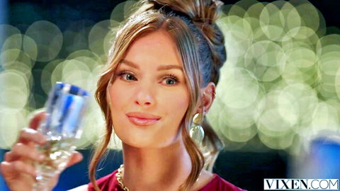 Jessi Rae stunning redhead in red dress holding wine glass seductively