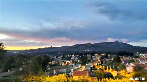 Scenic sunset over Mediterranean town with hills and houses, erotic video thumbnail