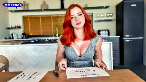 Redhead Russian teacher with big tits in low-cut gray top, seductive pose