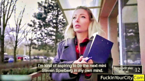 Blonde babe in coat holding folder outdoors aspiring to direct her next fuck scene