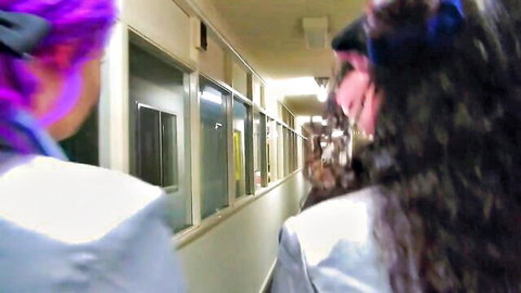 Two female bullies in school hallway, purple-haired vs brunette confrontation