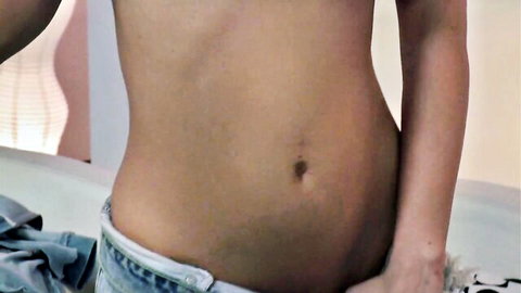 Slim fair-skinned babe's toned abs and navel with low-rise jeans pulled down teasing her smooth crotch