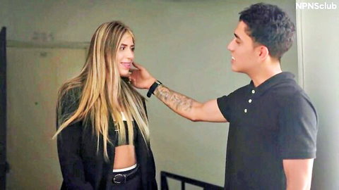 Blonde babe in sexy bralette flirts with tattooed Latino guy touching her face passionately