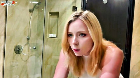 Topless blonde with huge tits makes surprised O-face in bathroom shower
