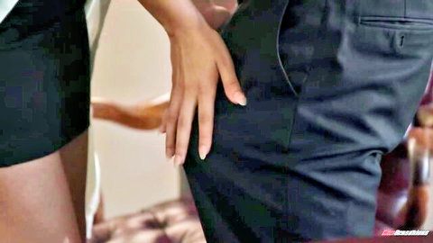 Hazel Heart in short black skirt gripping man's ass in intimate couple scene