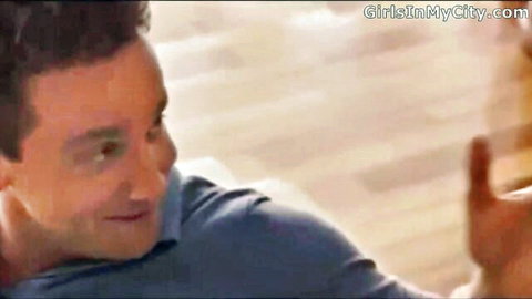 Smiling man in blue shirt gesturing hand on GirlsInMyCity.com adult video
