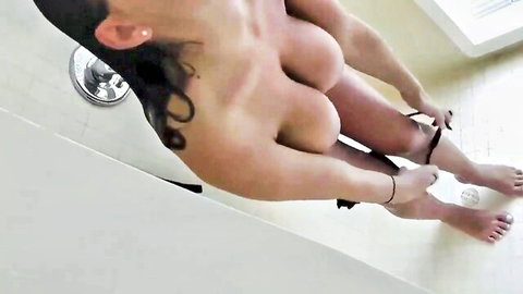 Topless tattooed babe with huge tits pulls down panties in shower exposing shaved pussy