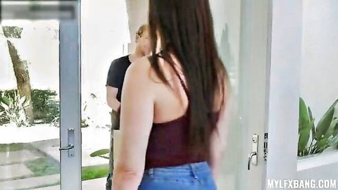 Brunette MILF in tight jeans showing off her small ass from behind at glass door with guy