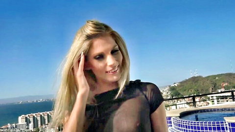 Candee Licious in sheer black top revealing breasts, poolside Puerto Vallarta