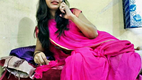 Mumbai Ashu in seductive pink saree, talking on phone on bed