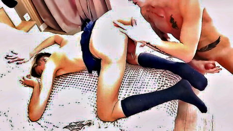 Tattooed muscular guy with big cock fucks young woman's exposed pussy doggy style on bed while she wears skirt and socks