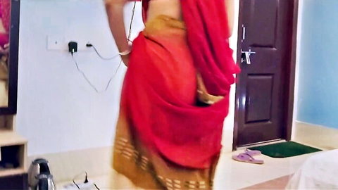 Desi Suman in red saree poses provocatively from behind