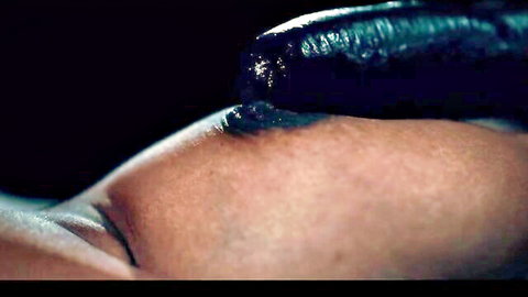 Close-up of woman with black tentacle on face and blue fluid in hentai parody