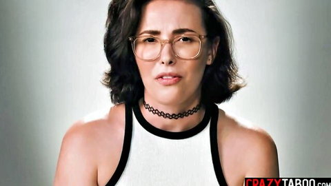 Casey Calvert in glasses and choker, teasing with sultry look in white top