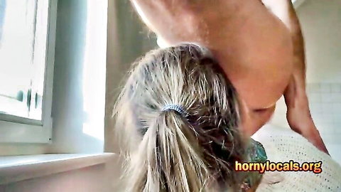 Blonde woman in ponytail gives intense blowjob to standing man, ending in orgasm
