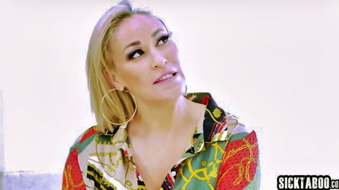 Seductive blonde MILF cougar pursing lips with hoop earrings in colorful shirt