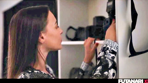 Brunette with long hair in skull top poses sideways in camera-filled closet