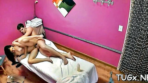 Asian babe with big tits fucked missionary style on massage table by naked masseur