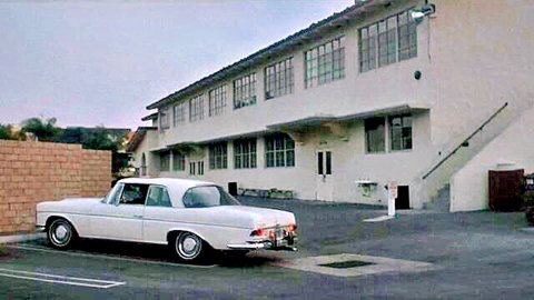 Kay Parker retro vintage scene with classic white car parked outside