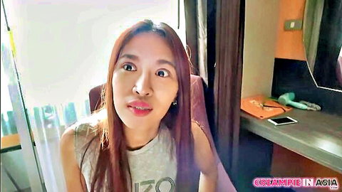 Surprised Asian woman in gray tank top, long hair, from Creampie In Asia studio