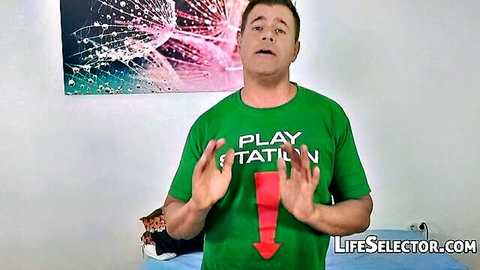 Man in Play Station t-shirt with red arrow pointing down to crotch gesturing excitedly for LifeSelector.com porn site