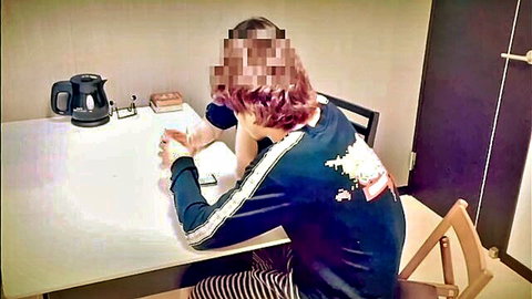 Blurry Asian guy in black tracksuit sitting at table, hands near crotch, gay amateur teaser