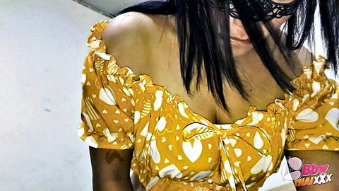 Asian MILF in yellow off-shoulder dress with mask, teasing cleavage