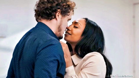 Curly-haired white guy passionately kisses sexy long-haired ebony woman in collared shirts