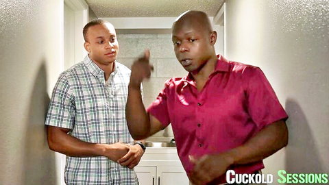 Two black men in plaid and red shirts gesturing in Cuckold Sessions kitchen scene
