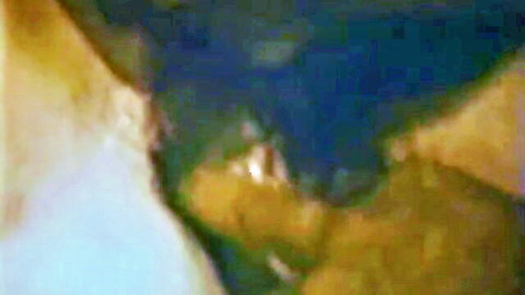 Blurry distorted closeup of yellowish skin tones and blue shadows in abstract adult scene