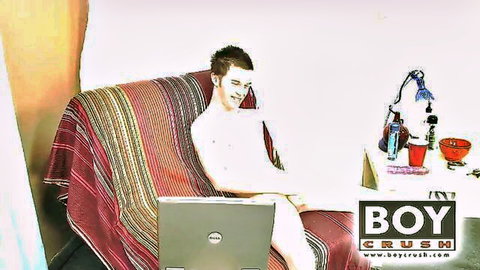 Nude twink Kevin Grey with laptop on lap in solo Boy Crush scene