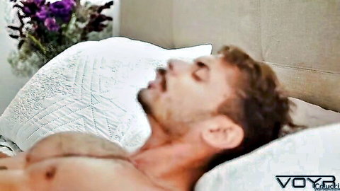 Colucci shirtless and relaxed on bed in passionate gay scene with Gael Riok