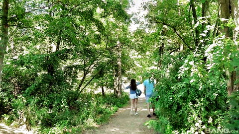 Diana Rius busty teen in short blue dress walks outdoor path with man, sensual tease